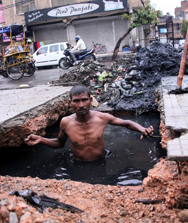 ***EXCLUSIVE*** ***NO INTERNET USE UNTIL 00-01 AUGUST 19, 2012*** NEW DELHI, INDIA - JULY 31: Devi Lal, 43, coming out of the drain on July 31, 2012 in New Delhi, India. THESE amazing pictures show what is probably the worlds filthiest job. Everyday thousands of manual scavengers in India unplug the dirtiest sewers and drains without any safety equipment or protection. It is also one the deadliest jobs in India, with almost 61 scavengers having died in last 6 months alone. According to Harnam Singh, the chairman of the Delhi Safai Karamchari Commision, ( Delhi cleaners commission) almost 70 percent of the manual scavengers die on the job. Even though India has banned Manual scavenging in 1993, government agencies still use thousands of manual scavengers to clean drains through out India. PHOTOGRAPH BY Sagar Kaul / Barcroft India UK Office, London. T +44 845 370 2233 W www.barcroftmedia.com USA Office, New York City. T +1 212 796 2458 W www.barcroftusa.com Indian Office, Delhi. T +91 11 4053 2429 W www.barcroftindia.com