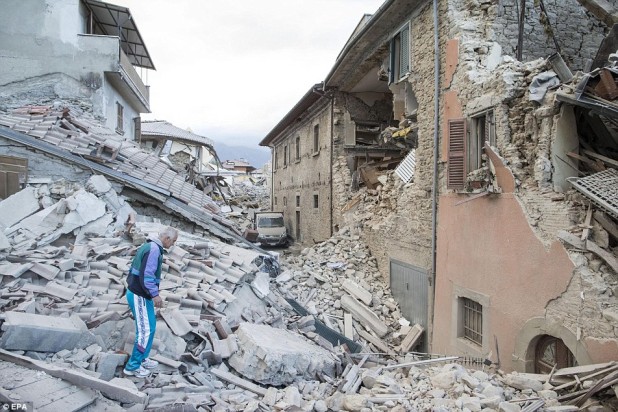 37897E6D00000578-3755722-Unimaginable_An_elderly_man_in_a_tracksuit_walks_on_the_rubble_o-a-19_1472054384831