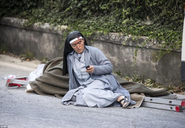 3789844400000578-3755722-Bloodied_An_injured_nun_checks_her_mobile_phone_as_she_lies_near-a-1_1472026812409