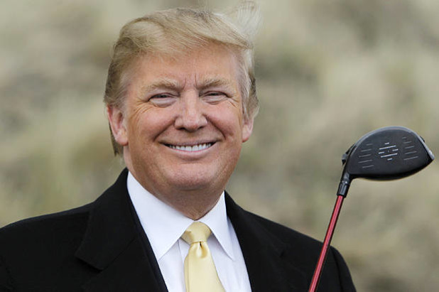 U.S. property mogul Trump holds a golf club during a media event on the sand dunes of the Menie estate