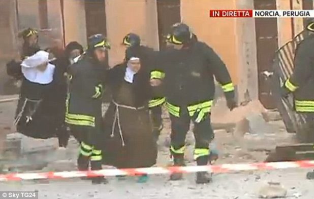 39de2ce100000578-3886712-an_elderly_nun_is_helped_by_emergency_crews_following_the_massiv-m-112_1477812156582