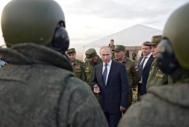 Russian President Vladimir Putin (C) attends a military exercises at the Donguzsky firing range in the Orenburg region, on September 19, 2015. AFP PHOTO / RIA NOVOSTI / ALEXEI NIKOLSKY (Photo credit should read ALEKSEY NIKOLSKYI/AFP/Getty Images)