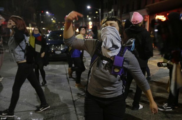 3a33360300000578-3922098-seattle_a_woman_yells_in_a_protest_against_donald_trump_in_seatt-a-22_1478776851435