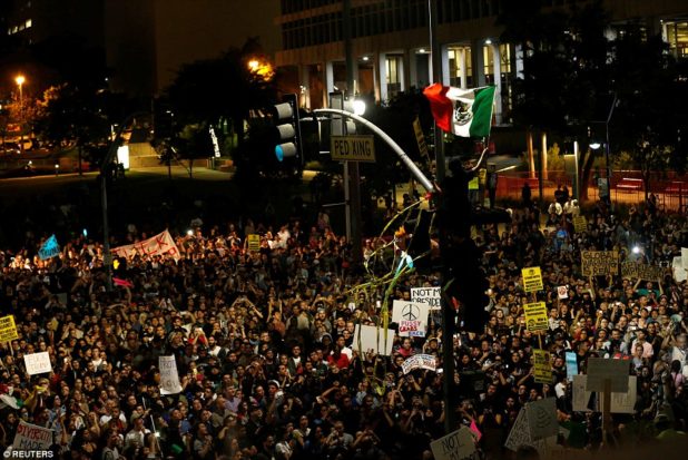 3a38bf8400000578-3922098-los_angeles_protester_waves_a_mexican_flag_outside_city_hall_in_-a-19_1478776851431