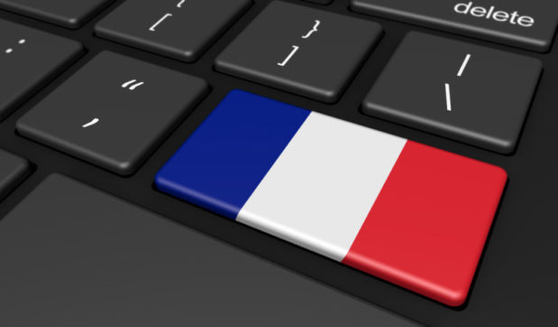 France digitalization and use of digital technologies concept with the French flag on a computer key.