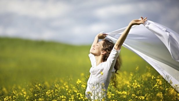 young-happy-woman-standing-in-field