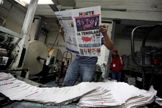 A worker reads a freshly printed newspaper with the headline reading "We will tremble" at a printer of the local daily Norte in Ciudad Juarez, Mexico. REUTERS/Jose Luis Gonzalez