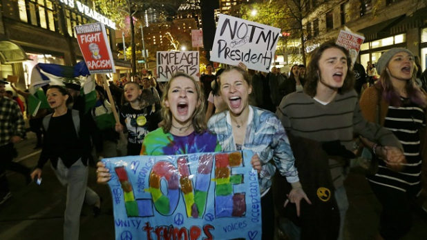 Protesters chant and hold signs during a protest against the election of President-elect Donald Trump, Wednesday, Nov. 9, 2016, in downtown Seattle. (AP Photo/Ted S. Warren)