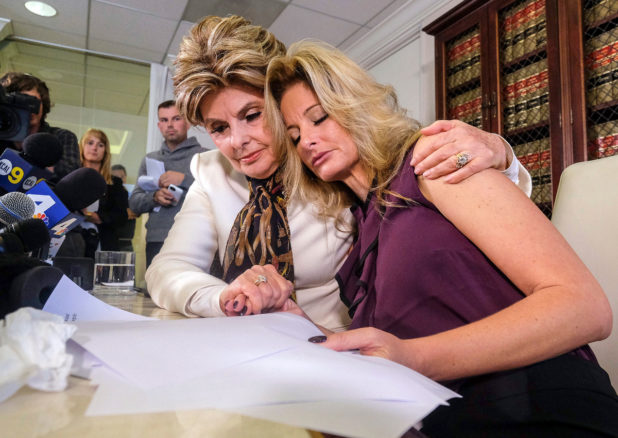 Attorney Gloria Allred, left, comforts Summer Zervos who accuses Donald Trump of victimizing her with inappropriate sexual conduct, during a news conference in Los Angeles on Friday Oct. 14, 2016. Summer Zervoshe latest woman to publicly accuse Trump of inappropriate behavior accusation. (AP Photo/Ringo H.W. Chiu)