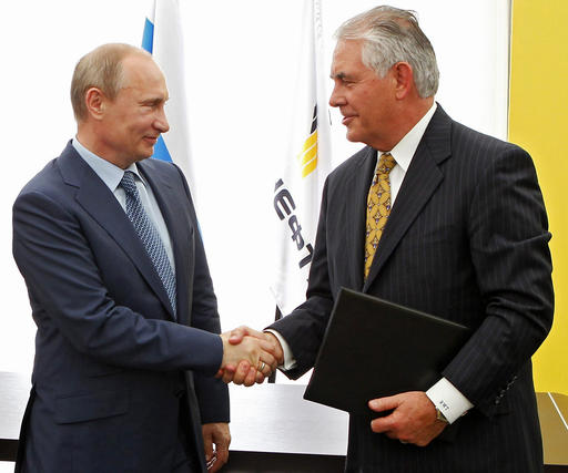 FILE- In this June 15, 2012, file photo, Russian President Vladimir Putin, left, and ExxonMobil CEO Rex Tillerson shake hands at a signing ceremony of an agreement between state-controlled Russian oil company Rosneft and ExxonMobil at the Black Sea port of Tuapse, southern Russia. President-elect Donald Trump selected Tillerson to lead the State Department on Monday, Dec. 12, 2016. (Mikhail Klimentyev/RIA-Novosti, Presidential Press Service via AP, Pool, File)