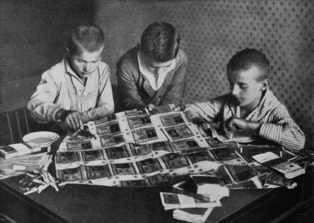Boys use worthless banknotes for arts and crafts. 1923.